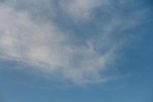 Endless azure sky with wispy clouds drifting lazily on a warm summer day photo