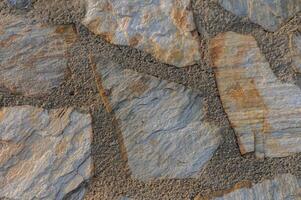 Intricate patterns of natural stone showcasing earthy tones and textures in a rustic setting photo