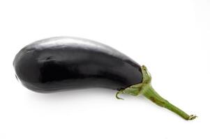 Fresh and glossy eggplant resting on a clean surface, ready for culinary adventures and delicious recipes photo
