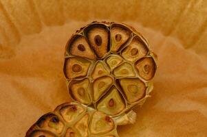 Exploring the intricate patterns of roasted garlic cloves in a warm golden hue photo