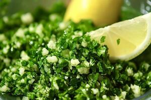 Tabbouleh with chopped parsley, mint, tomatoes, and lemon dressing photo