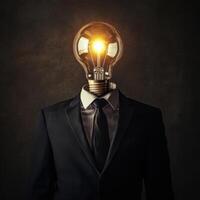 Creative representation of a business figure with a light bulb head symbolizing innovative ideas in an artistic concept photo