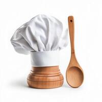 Chef hat and wooden spoon displayed together in a kitchen setting for culinary enthusiasts photo