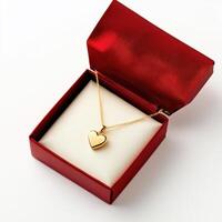 Heart-shaped gold necklace displayed in a red gift box for special occasions photo
