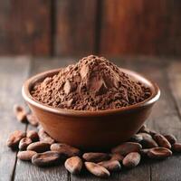Rich cocoa powder in a wooden bowl surrounded by cacao beans on a rustic wooden surface photo