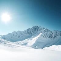 Bright sun shining over snow-covered mountain range in winter landscape with clear blue sky photo