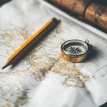 Exploring unknown territories with compass and map on a wooden surface photo