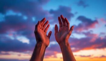Reaching for the Heavens, Open Hands Against a Vibrant Sunset Sky photo
