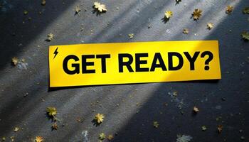A stark yellow banner demanding ,GET READY,, amidst fallen autumn leaves and stark shadows asks a silent question photo