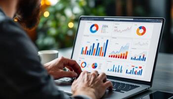 Business professional analyzes data visualization dashboards on laptop screen photo