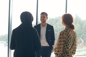 A business team engages in a lively discussion during a coffee break, exchanging challenges and sharing moments of laughter, fostering a positive and collaborative work environment photo