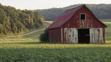 Weathered red barn in lush countryside with rolling hills and green fields photo