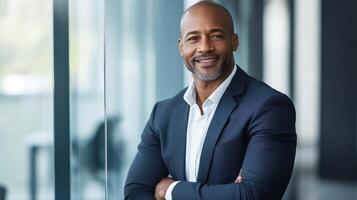 Confident male professional in business attire standing by office window photo