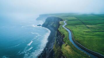 Scenic aerial view of misty coastal cliffs and rolling green fields in ireland photo