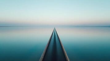 Tranquil highway reflecting on calm water at sunrise creating symmetry photo