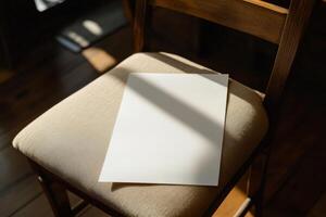 Sunlight illuminated blank paper on wooden chair seat in cozy setting photo