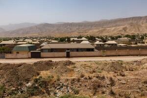 View of Obikiik village in Khuroson District, Khatlon Region, Tajikistan under clear skies photo