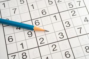 Sudoku puzzle game playing to challenge brain. photo