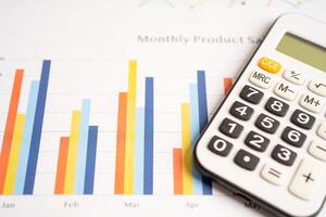 Calculator on chart graph paper. Finance, account, statistic, investment data economy, stock exchange business. photo