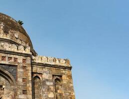 Ancient Indian building. Mughal stone architecture with decorative carvings, old dome. Historical photo