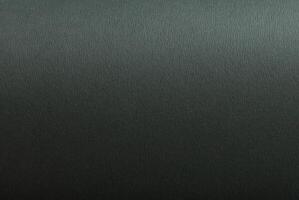 Green slate paper background with a matte finish and smooth, grainy texture. Olive green tones photo