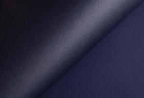 Midnight blue paper background with a gradient, curved matte surface, and subtle grainy texture. photo