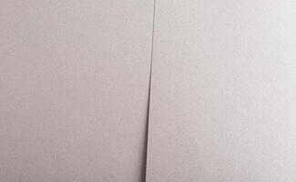 Gray paper background with a metallic, pearlescent finish and overlapping layers. Soft neutral tones photo