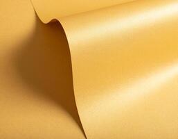 Honey gold paper background with a sleek, pearlescent texture and a shimmering, glossy finish. Warm photo