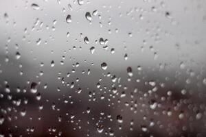 raindrops on window close up. Abstract background rain drop water macro texture. photo