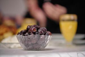 Eid mubarak Ramadan focus on a bowl of dates at the dining table at home. photo