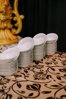 A neat stack of pristine white bowls awaits so nice photo