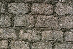 Rough and textured stone wall, perfect for backgrounds looks old photo