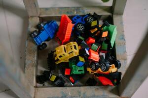 Pile of colorful toy trucks and blocks in a metal container, perfect for playtime so nice photo