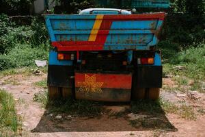 A colorful, weathered truck parked in a rural landscape so nice photo