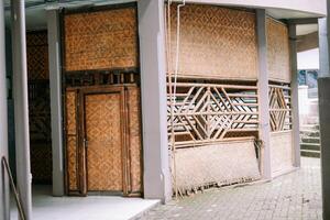 Traditional bamboo-woven building with intricate patterns, showcasing Indonesian craftsmanship. photo