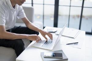 Business man working using laptop computer Hands typing keyboard. Professional investor working start up project. business planning in office. Technology business Concept photo