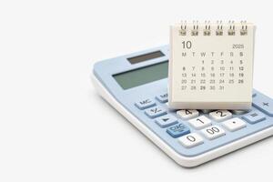 Simple desk calendar for 2025 OCTOBER on calculator. Calendar concept with copy space. 2025 OCT calendar. calculator and forecast for finances in 2025. photo