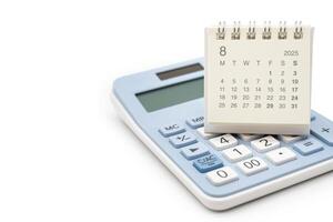 Simple desk calendar for 2025 AUGUST on calculator. Calendar concept with copy space. 2025 AUG calendar. calculator and forecast for finances in 2025. Money, Budget, investment and financial. photo
