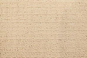 Close up of Cream colored Textured Fabric. Beige Textured Material. Textured Fabric Background. photo