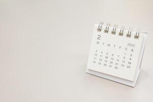 Simple desk calendar for 2025 FEBRUARY background. Calendar concept with copy space. 2025 FEB calendar. photo