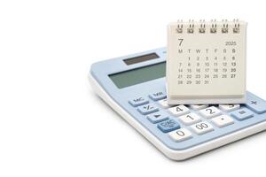 Simple desk calendar for JULY 2025 on calculator. Calendar concept with copy space. 2025 JUL calendar. calculator and forecast for finances in 2025. Money, Budget, tax, investment and financial. photo