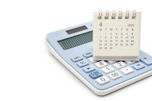 Simple desk calendar for 2025 APRIL on calculator. Calendar concept with copy space. 2025 APR calendar. calculator and forecast for finances in 2025. Money, Budget, tax, investment and financial. photo