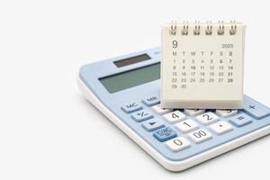 Simple desk calendar for SEPTEMBER 2025 on calculator. Calendar concept with copy space. 2025 SEP calendar. calculator and forecast for finances in 2025. Money, Budget, investment and financial. photo