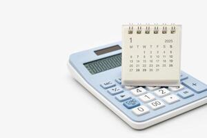 Simple desk calendar for JANUARY 2025 on calculator. Calendar concept with copy space. 2025 JAN calendar. calculator and forecast for finances in 2025. Money, Budget, tax, investment and financial. photo