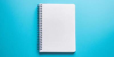 A spiral bound notebook with a blue background photo