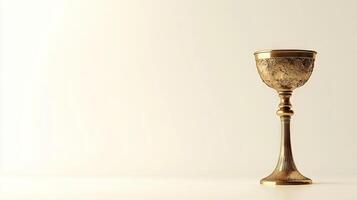 A gold cup sits on a white background photo