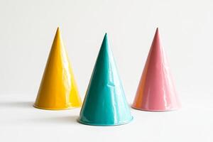 Colorful Party Hats in Yellow, Teal, and Pink Against a Minimalist White Background photo