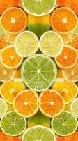A close up of many oranges and limes photo