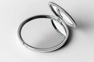 A silver mirror is opened and has a reflection of itself photo