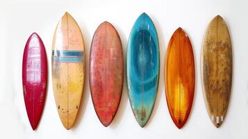A row of surfboards are hanging on a wall photo